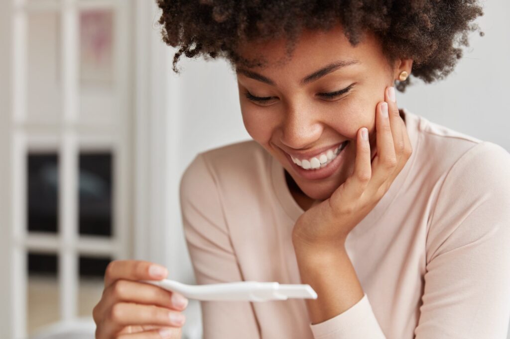 A woman holding a home pregnancy test