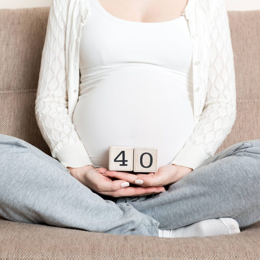 Woman holding blocks to demonstrate how many weeks pregnant she is and waiting with eager anticipation