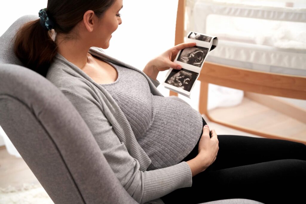Woman in advanced pregnancy browsing ultrasound scan and wondering if Premier Protein Shakes Safe During Pregnancy