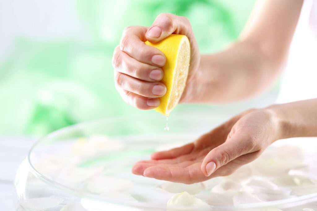 Woman squeezing lemon juice.