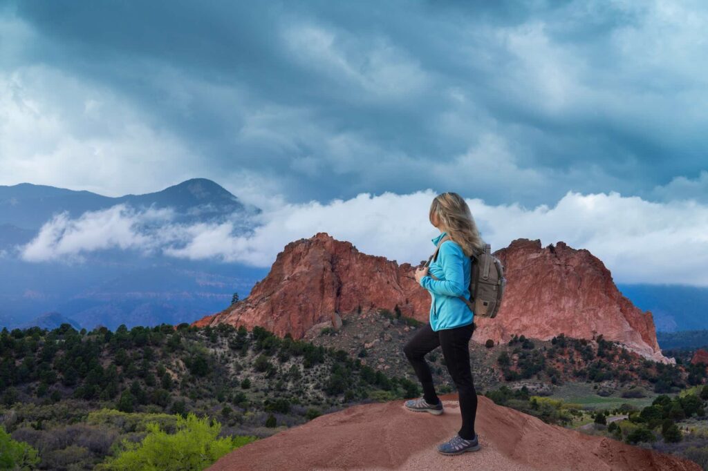 Woman hiking while pregnant first trimester at Garden of the Gods in Colorado Springs
